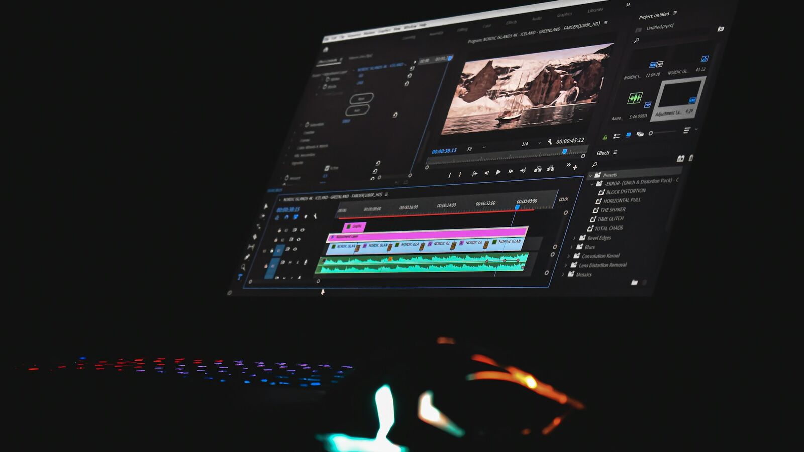 A video editing timeline on a monitor, cutting an interview segment into short clips